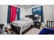 Modest bedroom with wood-look flooring, a black bed frame, and colorful character curtains at 7066 Jennie Dr, Denver, CO 80221
