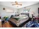 Cozy bedroom featuring hardwood floors, natural light, a ceiling fan, and a spacious layout at 7066 Jennie Dr, Denver, CO 80221