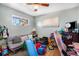 Bedroom featuring hardwood floors, natural light, and ample space for relaxation and play at 7066 Jennie Dr, Denver, CO 80221