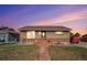 Charming single-story brick home featuring a well-maintained front lawn, pathway, and new roof at 7066 Jennie Dr, Denver, CO 80221