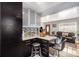 Stylish kitchen with granite countertops, dark cabinets, stainless steel appliances, and breakfast bar seating at 7066 Jennie Dr, Denver, CO 80221