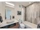 Bathroom features a modern vanity, stylish tile accents, and a combined tub and shower with modern fixtures at 4795 Highline Pl, Denver, CO 80222
