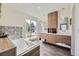 Modern bathroom featuring a soaking tub, double vanity, and large windows offering natural light at 4795 Highline Pl, Denver, CO 80222