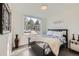 Bedroom with stylish bed, large bright window, and modern decor for a cozy and comfortable feel at 4795 Highline Pl, Denver, CO 80222