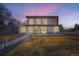 Modern two-story home features a sleek design with large windows and a welcoming patio at 4795 Highline Pl, Denver, CO 80222