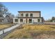 Modern home with clean lines, large windows, a well-maintained lawn, and a welcoming walkway at 4795 Highline Pl, Denver, CO 80222