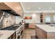 Modern kitchen boasts stainless steel appliances, quartz countertops, and sleek cabinetry at 4795 Highline Pl, Denver, CO 80222