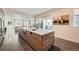 Modern kitchen featuring a large island with a sink, stainless steel appliances, and wood cabinetry at 4795 Highline Pl, Denver, CO 80222