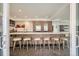 Stylish kitchen showcases a large island with seating, wood cabinets, and stainless steel appliances at 4795 Highline Pl, Denver, CO 80222