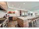 Bright kitchen features a large island with bar stool seating, stainless steel appliances, and ample counter space at 4795 Highline Pl, Denver, CO 80222