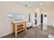 Bright laundry room with a modern stacked washer and dryer and a prep table with storage at 4795 Highline Pl, Denver, CO 80222