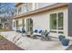 Comfortable outdoor patio featuring a cushioned sofa, rocking chairs, and potted plants, creating an inviting space at 4795 Highline Pl, Denver, CO 80222