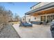 Stylish covered patio with an outdoor seating area and a fire table, perfect for cozy gatherings at 4795 Highline Pl, Denver, CO 80222