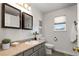 Bright bathroom with vanity, toilet, and window at 16530 Timber Cove St, Hudson, CO 80642