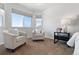 Relaxing bedroom with two armchairs and natural light at 16530 Timber Cove St, Hudson, CO 80642