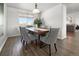 Dining room with hardwood floors and a large wooden table at 16530 Timber Cove St, Hudson, CO 80642