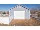 Detached garage with white door at 16530 Timber Cove St, Hudson, CO 80642