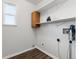 Laundry room with washer and dryer hookups and shelving at 16530 Timber Cove St, Hudson, CO 80642