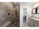 Large walk-in shower with gray tile and built-in seat at 16530 Timber Cove St, Hudson, CO 80642