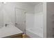 Well-lit bathroom with a tub, shower, white tiles, and vanity at 12292 E 2Nd Dr, Aurora, CO 80011