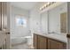 Bright bathroom with a vanity, mirror, and combination tub and shower at 12292 E 2Nd Dr, Aurora, CO 80011