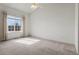 Sun-lit bedroom with a vaulted ceiling, neutral carpet, and a large window at 12292 E 2Nd Dr, Aurora, CO 80011