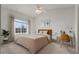 Bright bedroom featuring a large window, a work desk, neutral tones, and a ceiling fan at 12292 E 2Nd Dr, Aurora, CO 80011