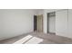 Neutral carpeted bedroom featuring a closet with sliding doors and paneled interior door at 12292 E 2Nd Dr, Aurora, CO 80011