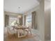 Well-lit dining room featuring a modern table, six chairs, and natural light, perfect for Gathering meals and entertaining at 12292 E 2Nd Dr, Aurora, CO 80011