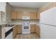 Efficient kitchen design with a breakfast bar and essential appliances at 12292 E 2Nd Dr, Aurora, CO 80011