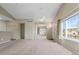 Bright living room with neutral carpet, ceiling fan, and view of the neighborhood at 12292 E 2Nd Dr, Aurora, CO 80011