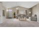 Bright living room featuring vaulted ceilings, a ceiling fan, and neutral-toned furniture for a cozy and inviting atmosphere at 12292 E 2Nd Dr, Aurora, CO 80011