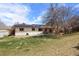 Extensive backyard featuring verdant grass, solar panels and mature trees at 4627 S Norfolk Way, Aurora, CO 80015