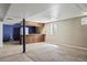 Finished basement with carpeted and tile flooring including a bar with wood paneling at 4627 S Norfolk Way, Aurora, CO 80015