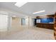 Finished basement featuring tile and carpet flooring with bar and bathroom at 4627 S Norfolk Way, Aurora, CO 80015