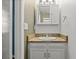 Compact bathroom with vanity, granite counter, mirror and cabinetry for storage at 4627 S Norfolk Way, Aurora, CO 80015