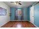 Bright bedroom features ample natural light, hard wood floors, and custom shelving at 4627 S Norfolk Way, Aurora, CO 80015