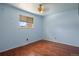 Bright bedroom with hardwood flooring, blue walls, and a window letting in lots of natural light at 4627 S Norfolk Way, Aurora, CO 80015