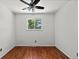 This bedroom features hardwood floors, a ceiling fan, and a bright window at 4627 S Norfolk Way, Aurora, CO 80015