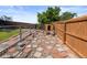 Fenced dog run area with decorative stone pathway is ideal for pet owners at 4627 S Norfolk Way, Aurora, CO 80015