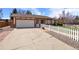 Charming single-story home with attached garage, white picket fence and well-maintained landscaping at 4627 S Norfolk Way, Aurora, CO 80015