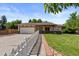Traditional home boasts mature landscaping and a walkway leading to the front door at 4627 S Norfolk Way, Aurora, CO 80015