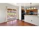 This charming kitchen features stainless appliances, a breakfast bar, and sliding glass doors to the backyard at 4627 S Norfolk Way, Aurora, CO 80015