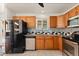 Well-maintained kitchen features oak cabinetry and stainless steel appliances at 4627 S Norfolk Way, Aurora, CO 80015
