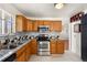 Well-equipped kitchen with modern appliances, granite countertops, and ample cabinet space at 4627 S Norfolk Way, Aurora, CO 80015
