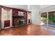 Cozy living room with brick fireplace, hardwood floors, and sliding glass doors to the backyard at 4627 S Norfolk Way, Aurora, CO 80015