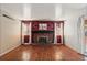 Spacious living room with hardwood floors and a classic brick fireplace at 4627 S Norfolk Way, Aurora, CO 80015
