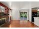 Bright living room featuring hardwood floors, brick fireplace, and access to the backyard at 4627 S Norfolk Way, Aurora, CO 80015
