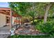 Relaxing outdoor space with a covered patio, BBQ pit, and scenic garden area at 4627 S Norfolk Way, Aurora, CO 80015