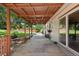 View of the covered patio with bench seating and concrete flooring, perfect for outdoor relaxation at 4627 S Norfolk Way, Aurora, CO 80015